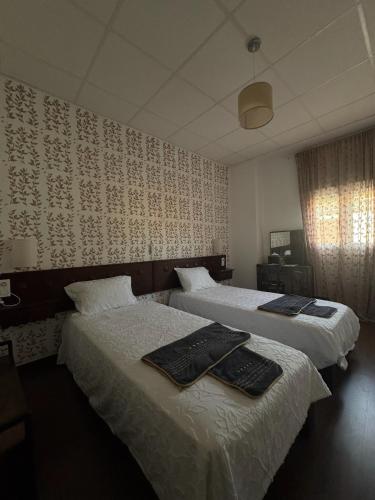 a hotel room with two beds with towels on them at El Palmar in Tobarra