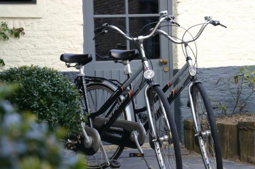two bikes parked in front of a house at Country House Duinhof in De Haan