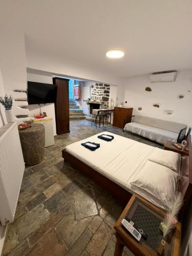 a bedroom with a large bed with a laptop on it at Dukes place in Mestá