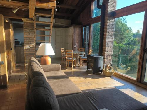a living room with a couch and a fireplace at Can Cirili Rustic Romantic apartment for couples or family events in Bordils
