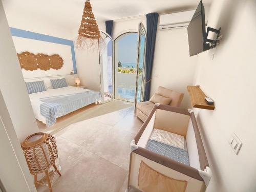 a bedroom with a bed and a tv in a room at Salento astrea vista mare in Porto Cesareo
