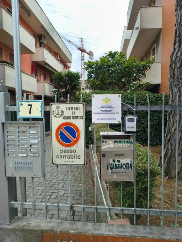 a bunch of signs on a fence in front of a building at Il sorriso romagnolo in Misano Adriatico