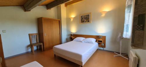 a bedroom with a white bed in a room at maison de vacances in Tourrettes