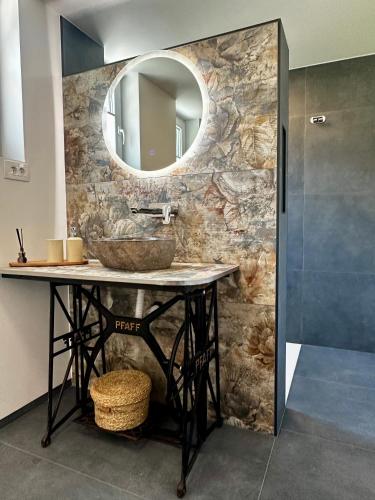a bathroom with a sink and a mirror at Hiša Srečo in Begunje na Gorenjskem