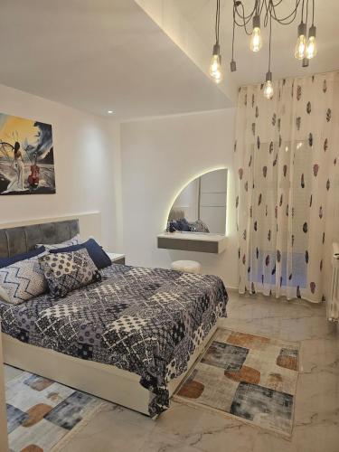a bedroom with a king sized bed and a rock wall at Nading flat in 'Aïn Benian
