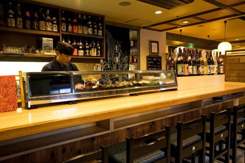 a man behind the counter of a bar at New Grande Mimatsu in Takamatsu