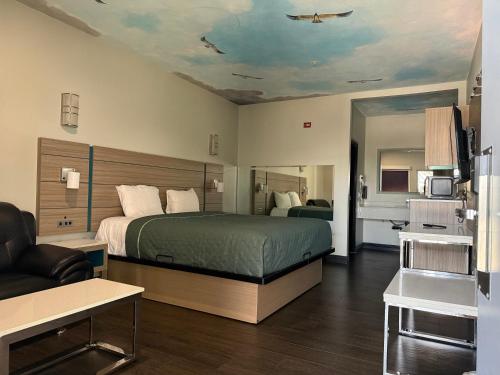 a hotel room with a bed and a couch at Crescent Inn in Wilmington