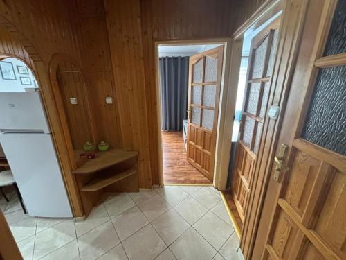 a kitchen with a white refrigerator and wooden walls at Biała Centrum in Biała Podlaska