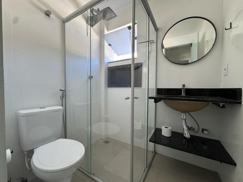 a bathroom with a toilet and a sink and a mirror at M e M executivo in Ipatinga