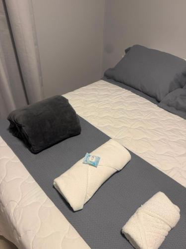 a bed with two towels and a pillow on it at UMARI Reserva Hotel in Marituba