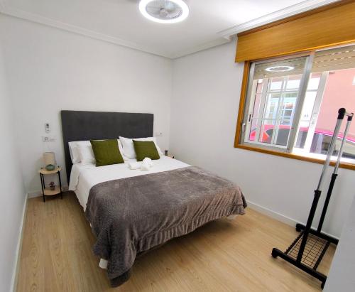 a bedroom with a large bed and a window at Casa Gaia Centrally located accommodation with spacious rooms in Redondela