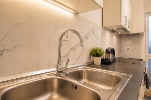 a stainless steel kitchen sink with a faucet at Villa Reve de Tirana in Tirana