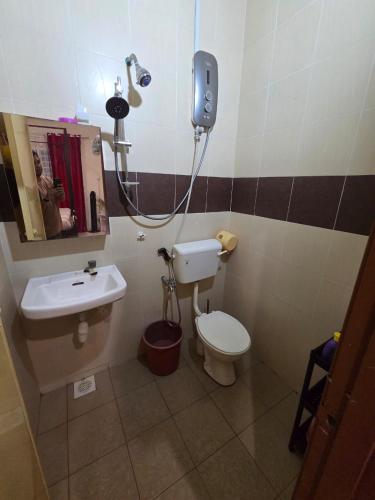 a bathroom with a toilet and a sink at Ctr Ruby homestay in Shah Alam