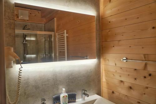 a bathroom with a sink and a mirror at Nassfeld Holiday Home in Rattendorf