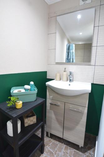 a bathroom with a sink and a mirror at Olympian Kavala in Kavála