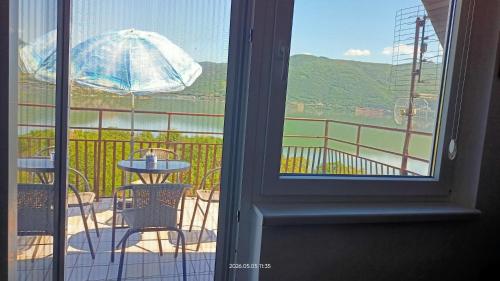 a view of a patio with a table and an umbrella at Apartman Đurić in Donji Milanovac