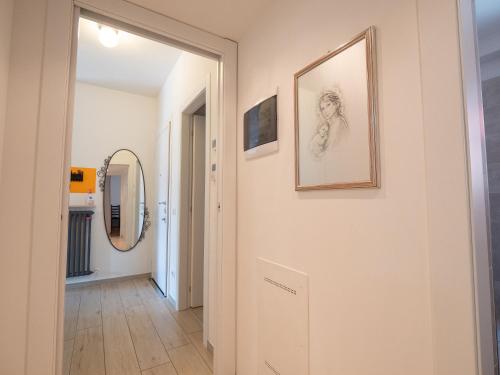 a hallway with a mirror and a picture on the wall at Bellanotte suite and dreams in Bellano