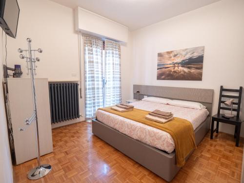a bedroom with a bed and a chair in it at Bellanotte suite and dreams in Bellano