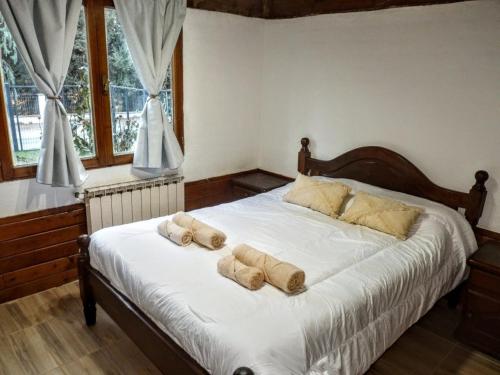 a bedroom with a bed with two pillows on it at Carreño Andino in San Carlos de Bariloche