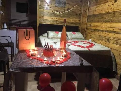 a room with a table with a cake and candles at Saghbine bungalows in ‘Ayn Zubdah
