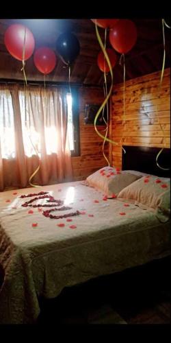 a room with a bed with balloons on it at Saghbine bungalows in ‘Ayn Zubdah