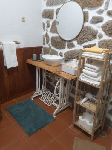 a bathroom with a sink and a mirror at Casa D'Zelo - Gerês in Montalegre