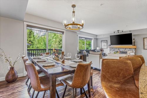 a dining room with a table and chairs at Rocky Mountain Condo with views of Grotto Mtn and hot tub in Dead Man's Flats