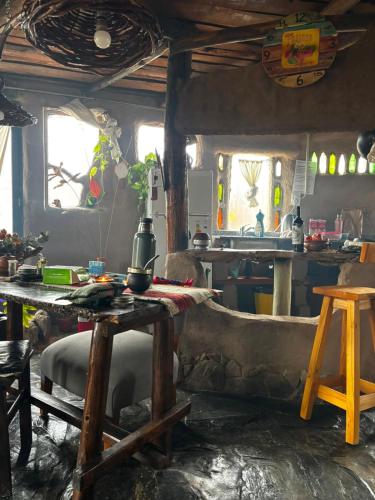 a living room with a table and a couch at Casa Madre in Villa Yacanto