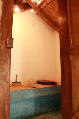 an open door to a room with two toilets at Espacio Circular Eco Hostel in San Marcos Sierras