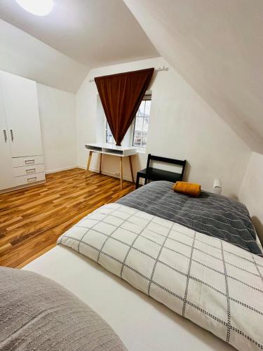 a bedroom with a large bed and a table at Apartment in Måløy in Måløy