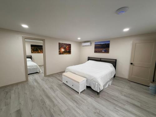 a bedroom with two beds and paintings on the wall at Alpine Adventures Inn in Alpine