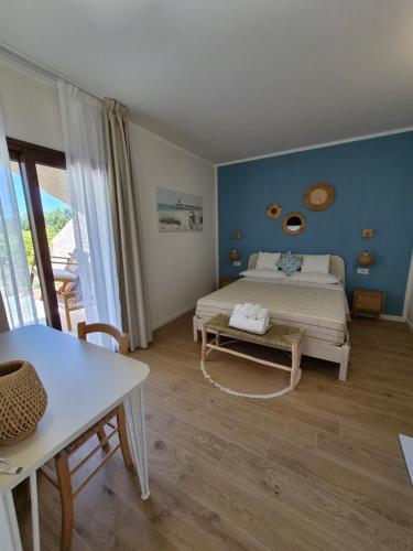 a bedroom with a bed and a table and a table at Karasole in San Teodoro