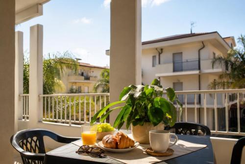 a table with a plate of food on a balcony at CIVICO33 in Rocca Imperiale