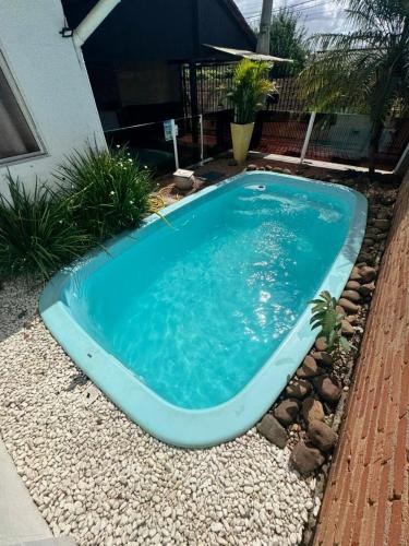 a swimming pool in the middle of a yard at 10 - Casa completa com piscina, Wi-Fi e Garagem in São Leopoldo