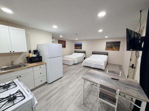a kitchen with two beds and a white refrigerator at Alpine Adventures Inn in Alpine
