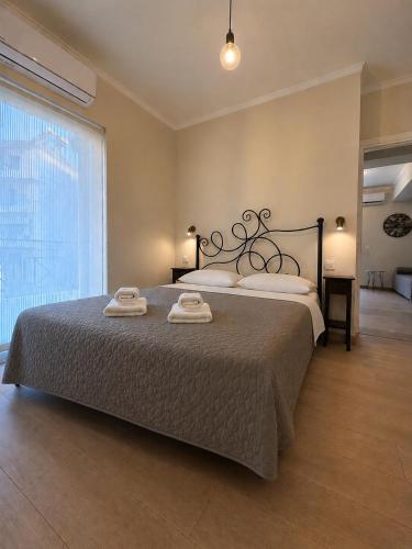 a bedroom with a large bed with two towels on it at Angelland Luxury Suites in Nafpaktos