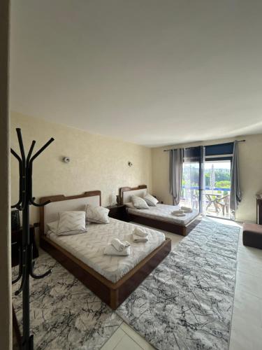 a bedroom with two beds and a balcony at Chez Bouchra Suite familiale in Pont Blondin