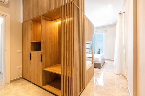 a room with a wooden cabinet with a bed in it at New Dhermi Icon 3 - Parking in Dhërmi