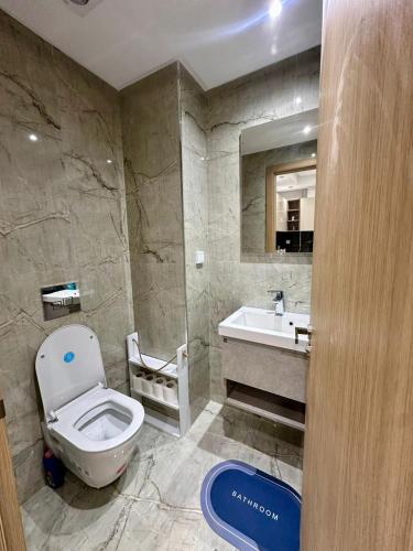 a bathroom with a toilet and a sink at Cozy Urban Nest in La Marsa