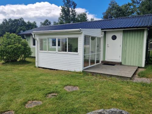 a house with a porch and a deck at Havsnära stuga in Varberg