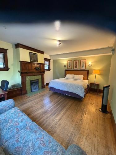 a bedroom with a bed and a fireplace at Van Guesthouse in Vancouver