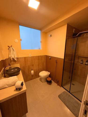 a bathroom with a shower and a toilet and a sink at 1101 Barra Salvador - Excelente para o Carnaval! in Salvador