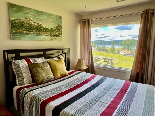a bedroom with a bed and a window with a view at Imperial Ranchettes GuestSuite in Lone Butte