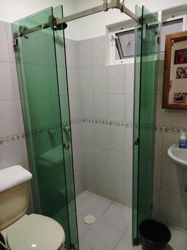 a bathroom with a shower with a toilet and a sink at Casa Lago de Luz in San Juan Cosalá