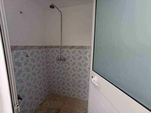 a bathroom with a shower with a tiled wall at Dar arbi in Kelibia