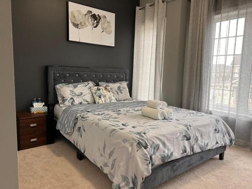 a bedroom with a bed with a teddy bear on it at The Grand Maple Residence in Brampton