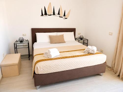 a bedroom with a bed with towels on it at Case Vacanze Porto Vecchio in Lampedusa