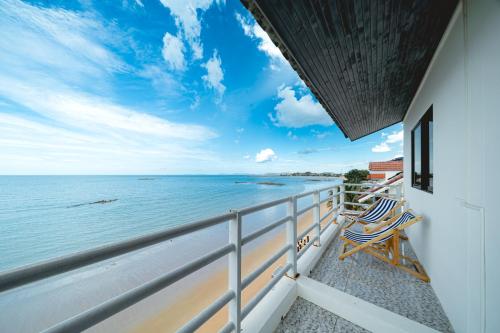 a balcony with two chairs and a view of the ocean at Gao Lighthouse Phala Beach in Ban Phala