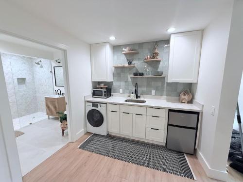a kitchen with a sink and a dishwasher at Kona Hang Loose Studio in Kailua-Kona