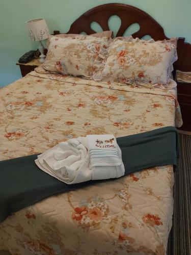 a bed with a blanket and a towel on it at LeMarida Suites in Saint Peter